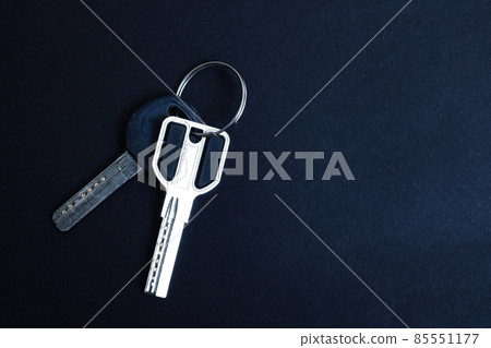 Door keys on a black background closeup Door keys on a black background closeup 85551177