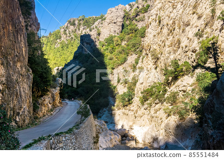 road is laid along the bottom of the mountain gorge with steep limestone slopes 85551484