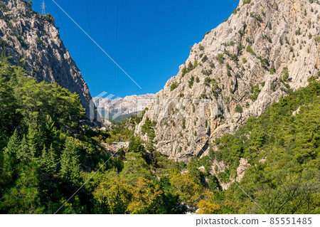 power transmission line was laid in a mountain gorge with steep limestone slopes power transmission line was laid in a mountain gorge with steep limestone slopes 85551485