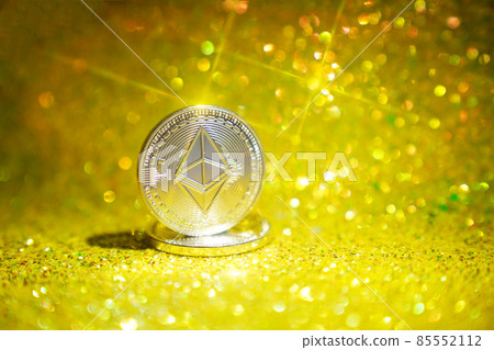 The reverse side is ether. Cryptocurrency ether is the coin of the future. Golden ether. Golden shiny background. High quality photo 85552112