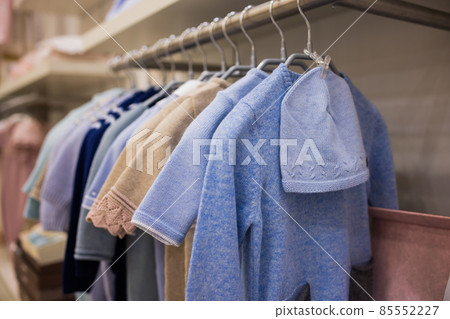 closeup of baby clothes on rack in a flea market. closeup of baby clothes on rack in a flea market. 85552227