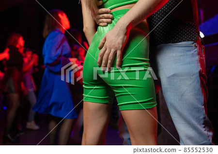 Man's hands grabbing a girl's backside close-up. 85552530