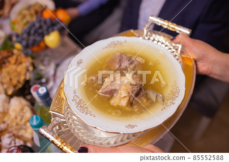 Delicious beef broth, a traditional dish made with beef bone and vegetables. Delicious beef broth, a traditional dish made with beef bone and vegetables. 85552588