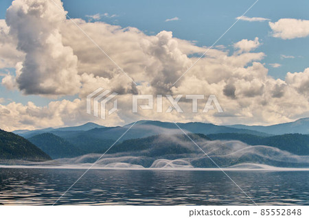 Fog in the mountain valley. Morning fog over the lake in the Altai mountains. Fog in the mountain valley. Morning fog over the lake in the Altai mountains. 85552848