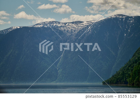 Landscape with boats in the water lake with views of the mountains. Teletskoye Lake Altai in Siberia. Landscape with boats in the water lake with views of the mountains. Teletskoye Lake Altai in Siberia. 85553129