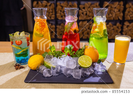 fruit and berry lemonades on the wooden tray with spruce. 85554153