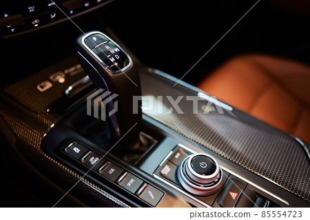 Automatic gear stick of a modern car, multimedia and navigation control buttons. Car interior details. Transmission shift. Shallow dof 85554723