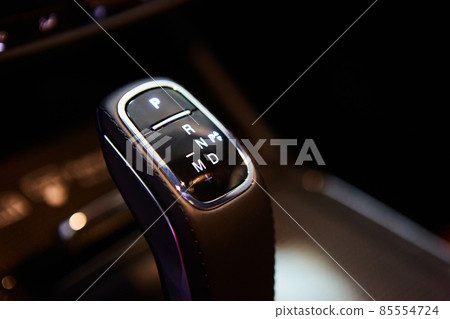 Automatic gear stick of a modern car, multimedia and navigation control buttons. Car interior details. Transmission shift. Shallow dof Automatic gear stick of a modern car, multimedia and navigation control buttons. Car interior details. Transmission shift. Shallow dof 85554724