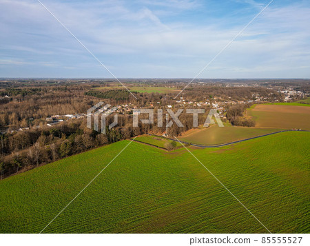 Areal view of agricultural field against cloudy sky 85555527