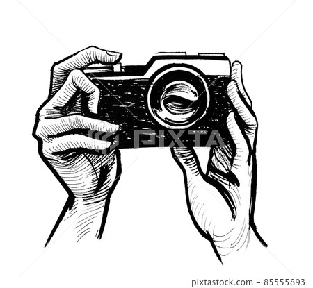 Hands holding camera. ink black and white drawing 85555893