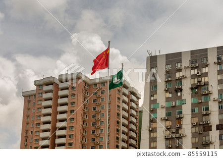 Flags of China and SAR Macau in front of residential buildings in Macau, China Flags of China and SAR Macau in front of residential buildings in Macau, China 85559115