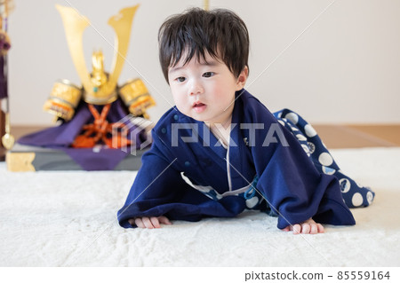 First clause: A boy sitting in front of a helmet First clause: A boy sitting in front of a helmet 85559164