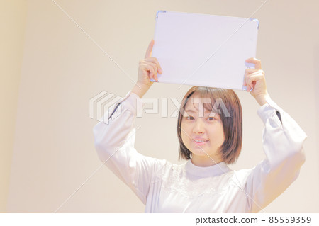 Young woman holding a message board over her head 3 Young woman holding a message board over her head 3 85559359