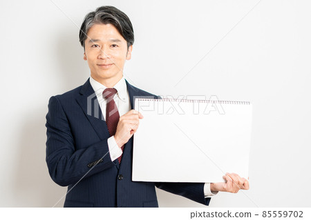 A businessman with a white board A businessman with a white board 85559702