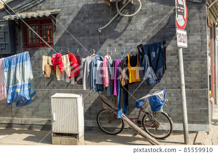 Laundry hanging for air drying in a small hutong alley in Beijing, China Laundry hanging for air drying in a small hutong alley in Beijing, China 85559910
