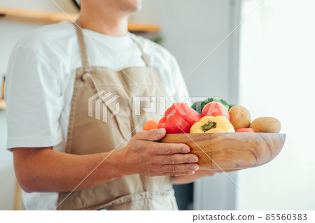 A man standing in the kitchen (vegetables, no face) A man standing in the kitchen (vegetables, no face) 85560383
