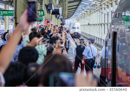 A large number of fans gather in front of the E4 Series Shinkansen 85560640