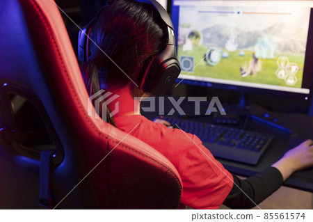 Image of e-sports tournament Girl at hand playing a game while sitting on a gaming chair 85561574