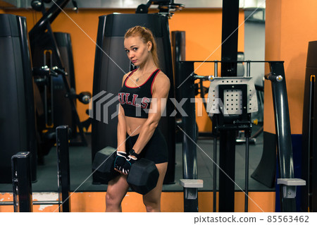 Athletic strong attractive woman in the gym, training and smiling 85563462