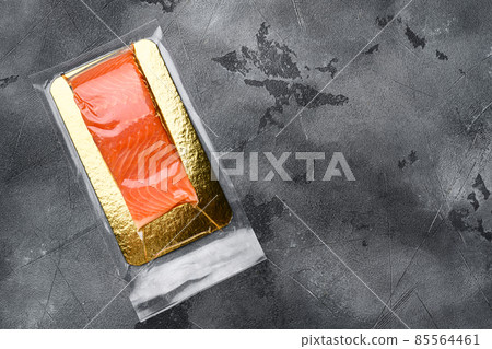 Salmon fillet vacuum pack fish meat, on gray stone table background, top view flat lay, with copy space for text 85564461