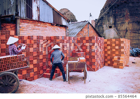 Workers in the traditional brick-making village along the banks of the Co Chien River in Vinh Long Province, Vietnam Workers in the traditional brick-making village along the banks of the Co Chien River in Vinh Long Province, Vietnam 85564464