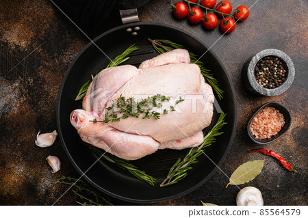 Whole raw free range chicken, on old dark rustic table background, top view flat lay Whole raw free range chicken, on old dark rustic table background, top view flat lay 85564579