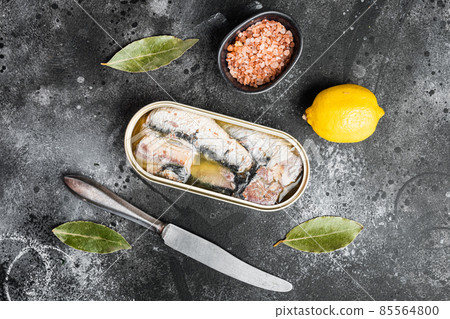 Canned sardine in oil, on black dark stone table background, top view flat lay Canned sardine in oil, on black dark stone table background, top view flat lay 85564800