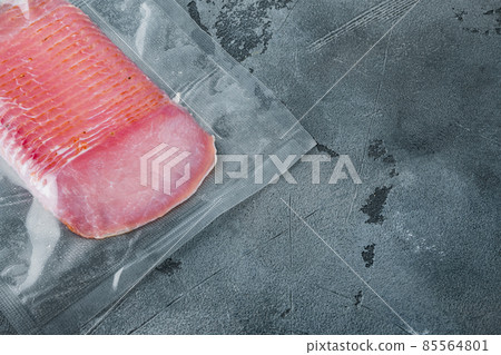Cured meat pork ham, vacuum packed, on gray stone background, with copy space for text Cured meat pork ham, vacuum packed, on gray stone background, with copy space for text 85564801