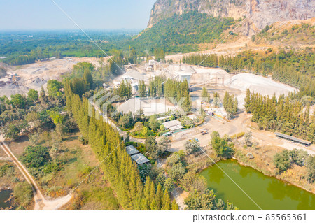 Aerial view of machine excavator trucks dig coal mining or ore with black grunge stone on ground in quarry with mountain hills. Nature landscape background in factory industry. Environment resources 85565361