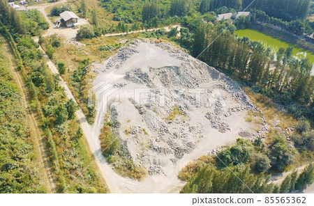 Aerial view of machine excavator trucks dig coal mining or ore with black grunge stone on ground in quarry with mountain hills. Nature landscape background in factory industry. Environment resources 85565362