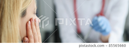 Woman at doctor appointment with toothache closeup Woman at doctor appointment with toothache closeup 85565660