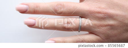 Silver ring with small stones on woman hand 85565687