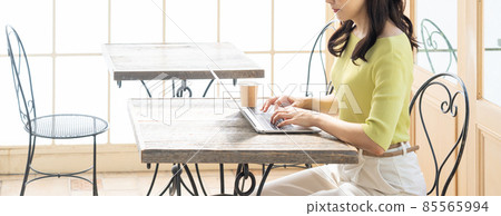 Young woman (business) working at a cafe using a computer Young woman (business) working at a cafe using a computer 85565994