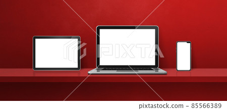 Laptop, mobile phone and digital tablet pc on red wall shelf. Banner background Laptop, mobile phone and digital tablet pc on red wall shelf. Banner background 85566389