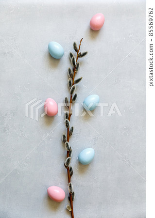 Happy Easter concept. Preparation for holiday. Colorful decorated easter eggs willow on concrete stone grey background. Simple minimalism flat lay top view copy space 85569762