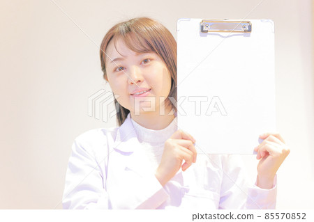 White coat woman smiling with a binder 1 85570852