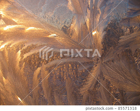 Beautiful ice pattern and sunlight closeup on window glass 85571318