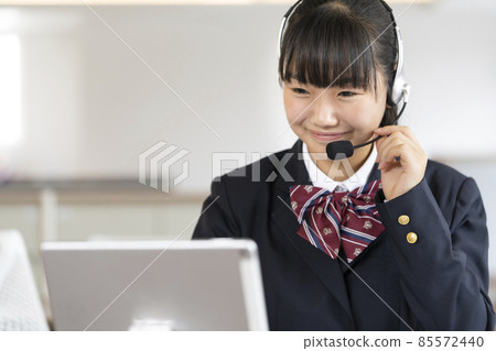 Image of a female student online class wearing a headset and heading to a tablet 85572440