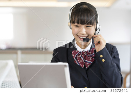 Image of a female student online class wearing a headset and heading to a tablet 85572441