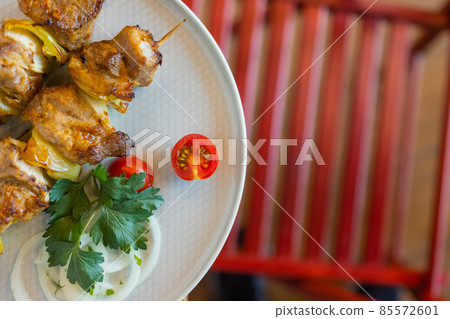 Shish kebab - delicious meat cuisine with zucchini, onions and peppers. Shish kebab - delicious meat cuisine with zucchini, onions and peppers. 85572601