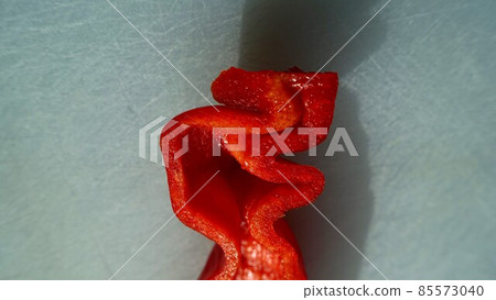 Photo of the head of a red pepper cut in half. 85573040