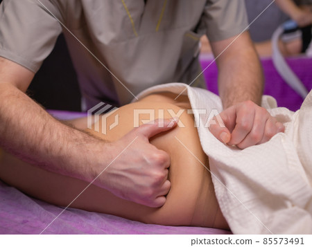 relaxing pain. fabulous full foot massage.close up side view cropped photo. relaxing pain. fabulous full foot massage.close up side view cropped photo. 85573491