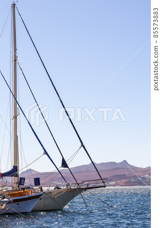 Sailboats in the blue sea against the backdrop of islands and mountains. Sports and summer vacations concept 85573883