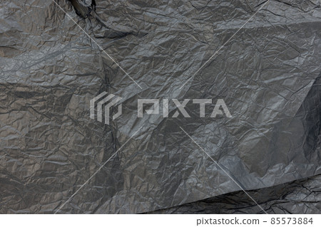 Used crumpled black wrapping paper texture background Used crumpled black wrapping paper texture background 85573884