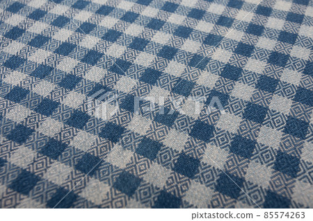 Close up of texture of hand woven plaid shawl 85574263
