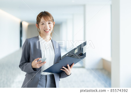 Portrait of a young business woman standing in the office corridor "LINK FOREST" Portrait of a young business woman standing in the office corridor "LINK FOREST" 85574392