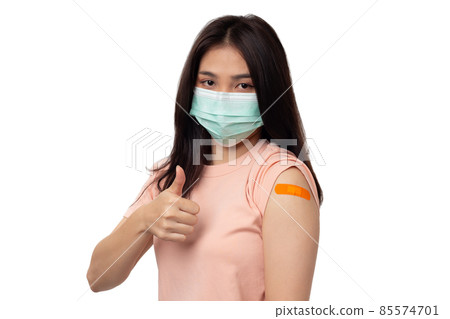 Young Asian Woman wearing medical face mask Protection versus virus with thumbs up for vaccination, and protection coronavirus,  covid 19 concept on white background, 85574701