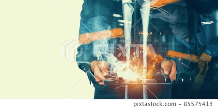 Mechanized industry robot arm and factory worker double exposure Mechanized industry robot arm and factory worker double exposure 85575413