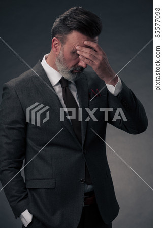 Frustrated middle aged elegant man Close up face of stressed businessman wearing stylish suit with eyes closed. Overworked middle eastern business man with terrible migrain Frustrated middle aged elegant man Close up face of stressed businessman wearing stylish suit with eyes closed. Overworked middle eastern business man with terrible migrain 85577098