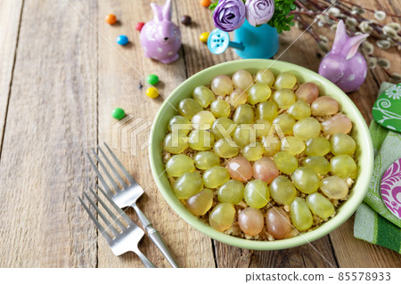 Holiday food, easter salad. Salad with chicken, cheese, walnuts and grapes on a festive table. 85578933
